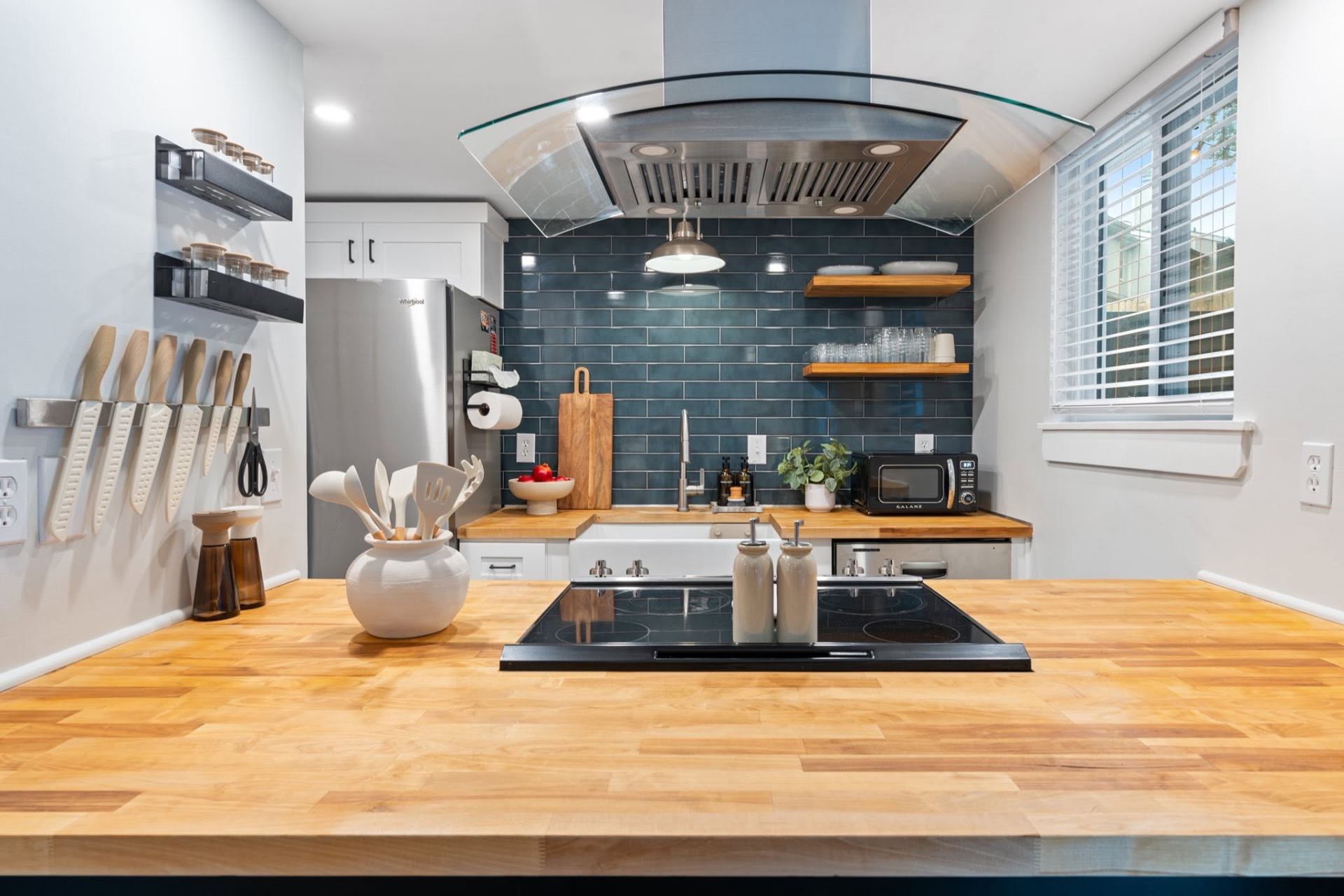 Butcher-block kitchen with deep teal backsplash